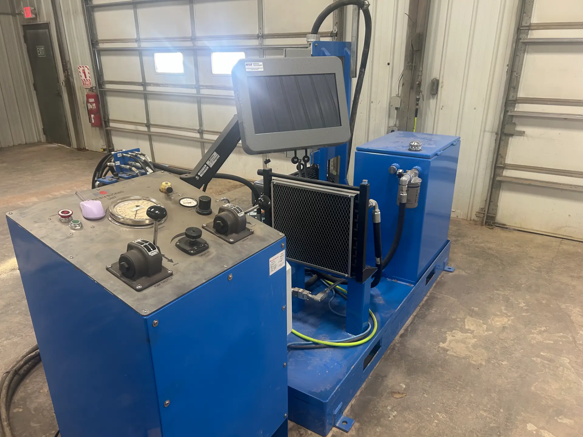Blue NOV bucking unit hydraulic power pack with monitor and cooler in the WOS shop