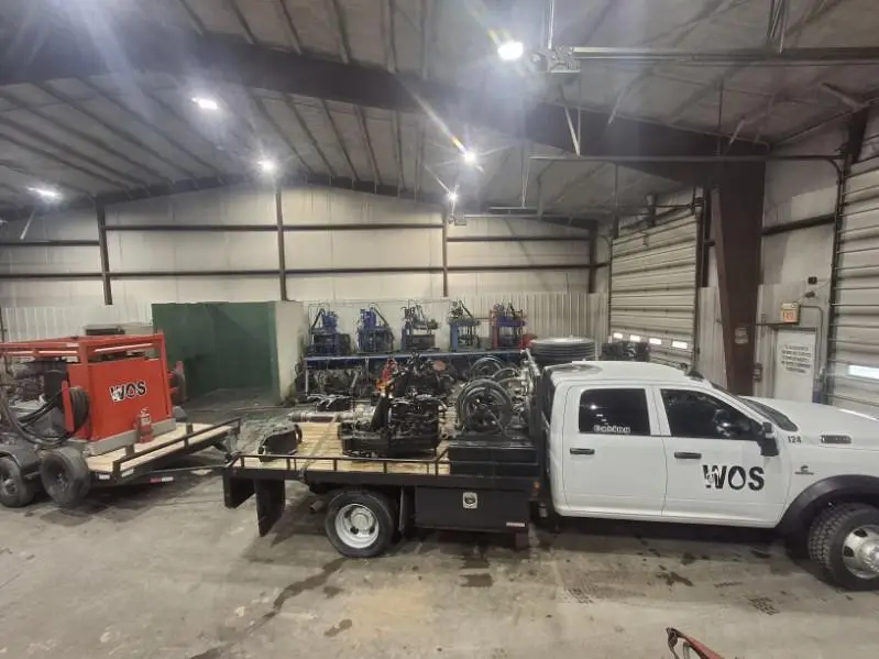 WOS truck and trailer loaded with CRT units inside the Williston shop