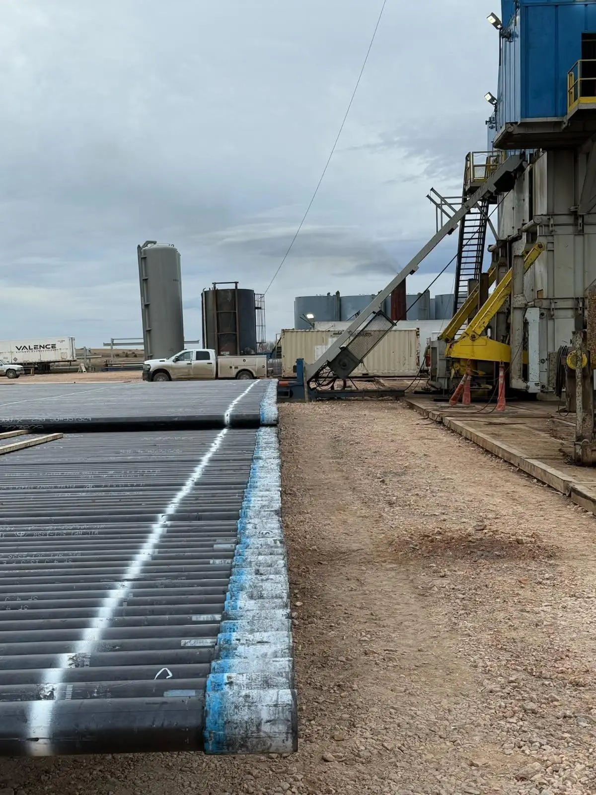 Casing yard with rig in background