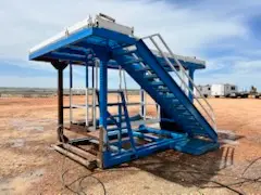 Blue mud system staircase and platform staged on a Bakken pad