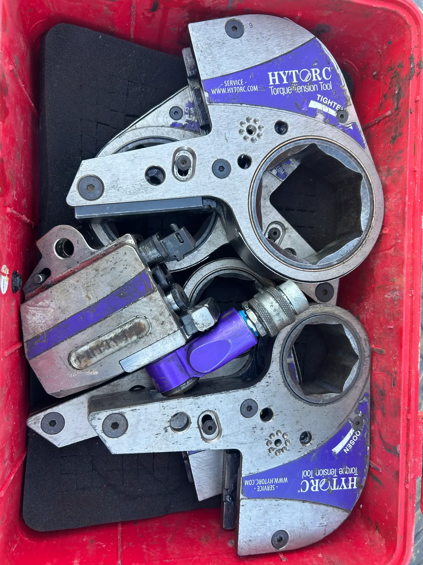 HYTORC hydraulic torque wrench heads and pump in a red carrying case ready for field service