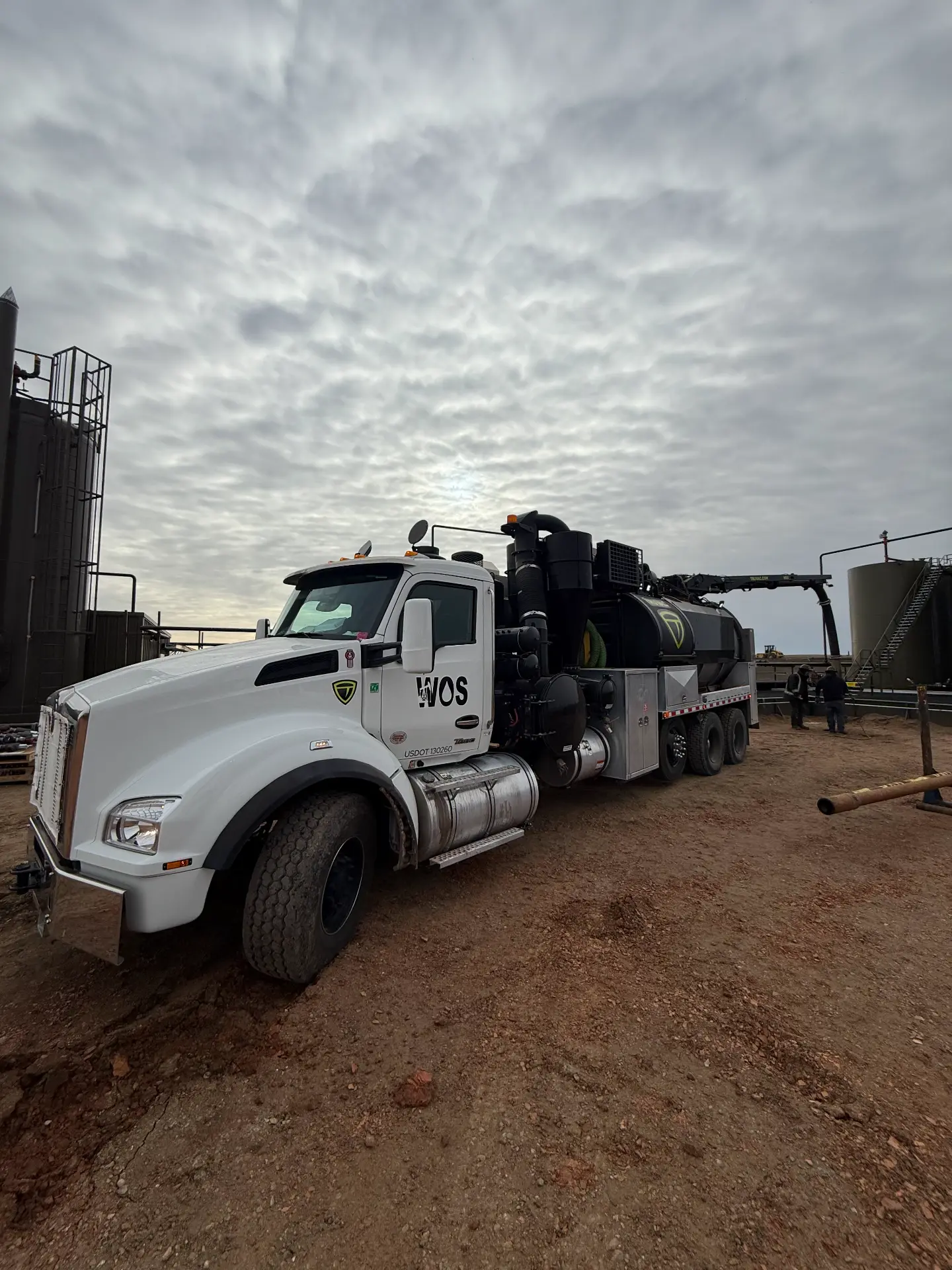 WOS hydrovac truck staged at a Bakken tank battery
