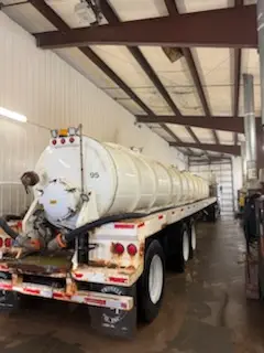Crew member washing a tanker trailer inside the WOS heated indoor wash bay