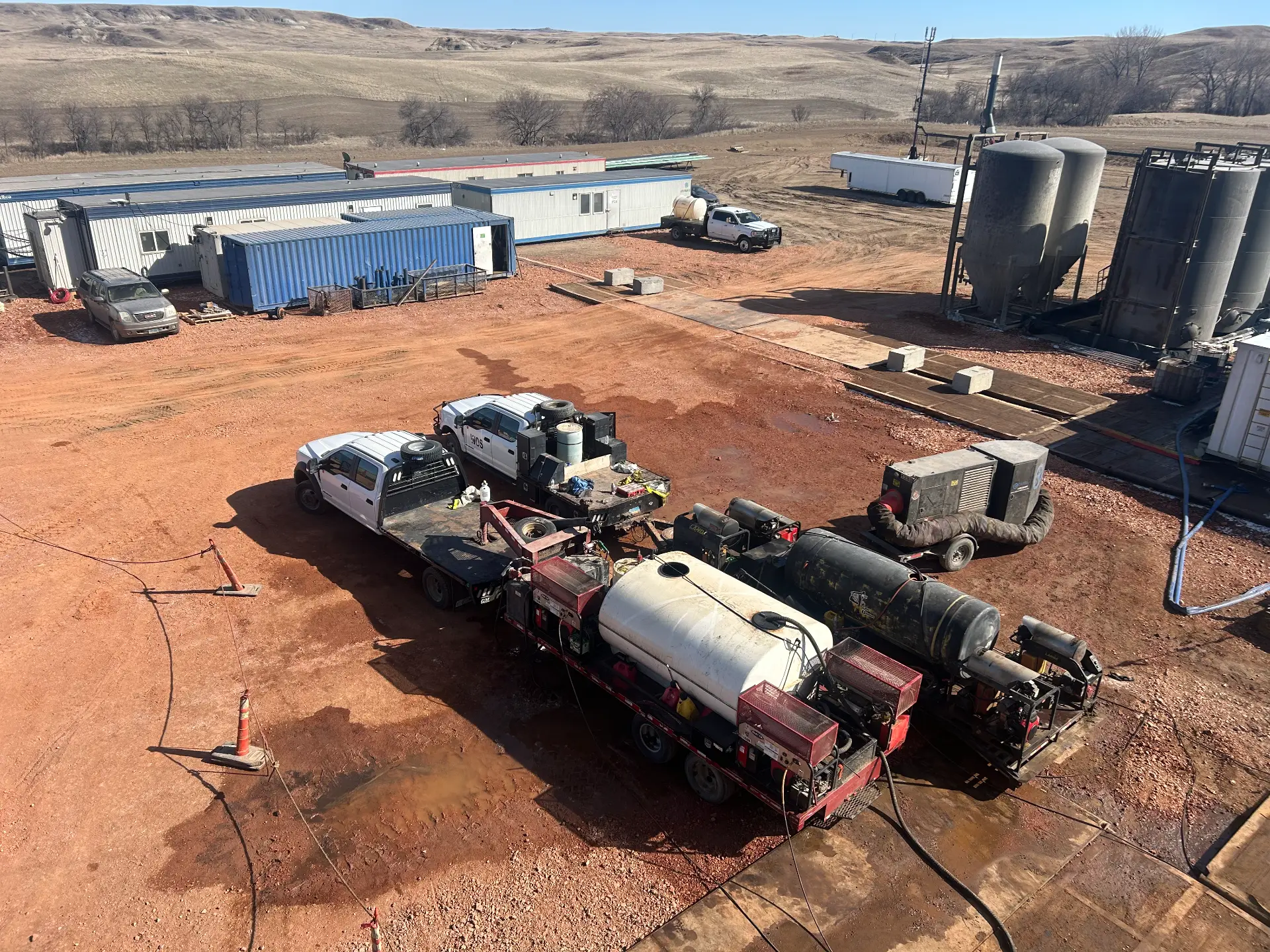 Aerial of WOS pressure-wash flatbed and hot-water units staged at a Bakken facility