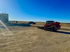 Skidsteer preparing a wellsite pad