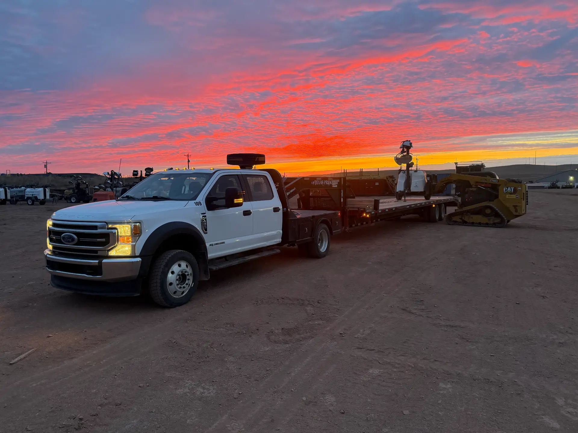 WOS service truck and trailer at sunset on a Bakken yard