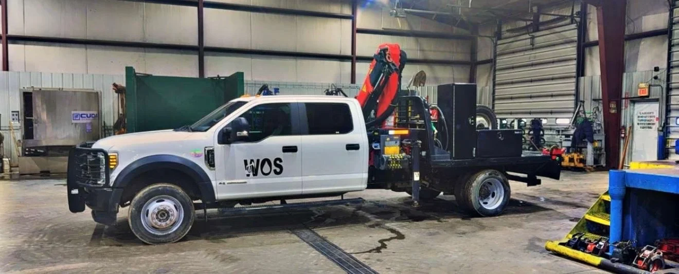 WOS knuckle-boom service truck staged in the shop