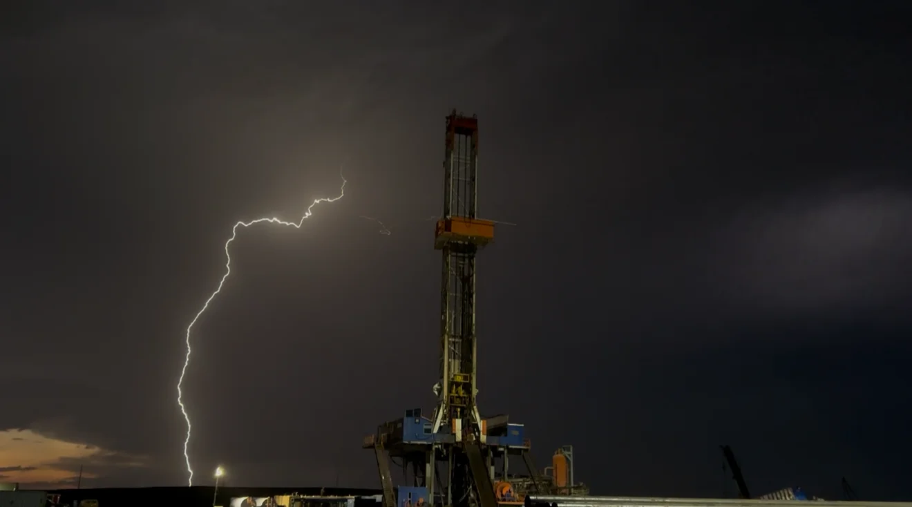 Drilling rig under a stormy sky with lightning strike near the Bakken