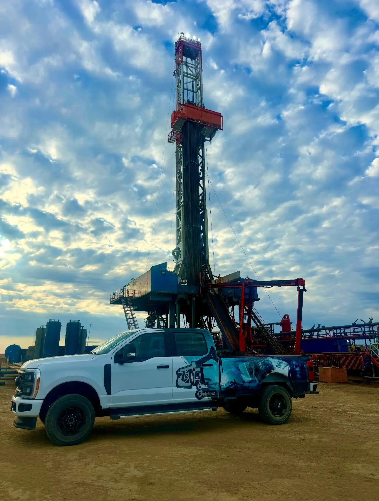 Well Oiled Solutions branded service truck on location at a Bakken drilling rig